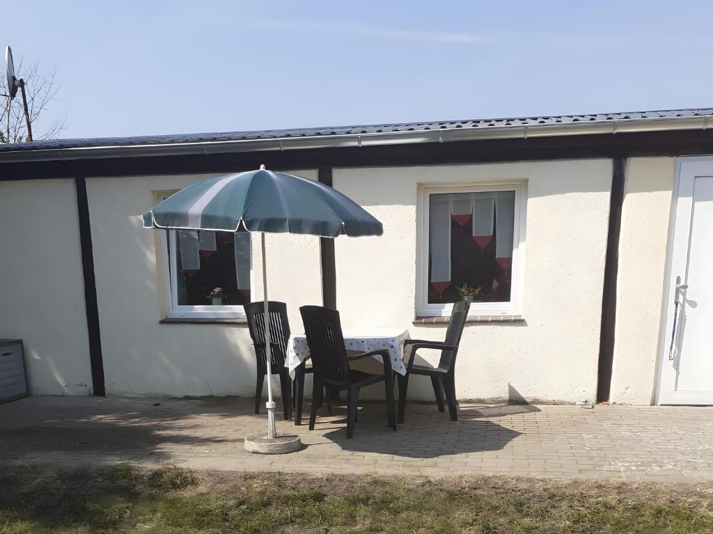 a table and chairs under an umbrella on a patio at Ferienhaus Fechter in Lanz
