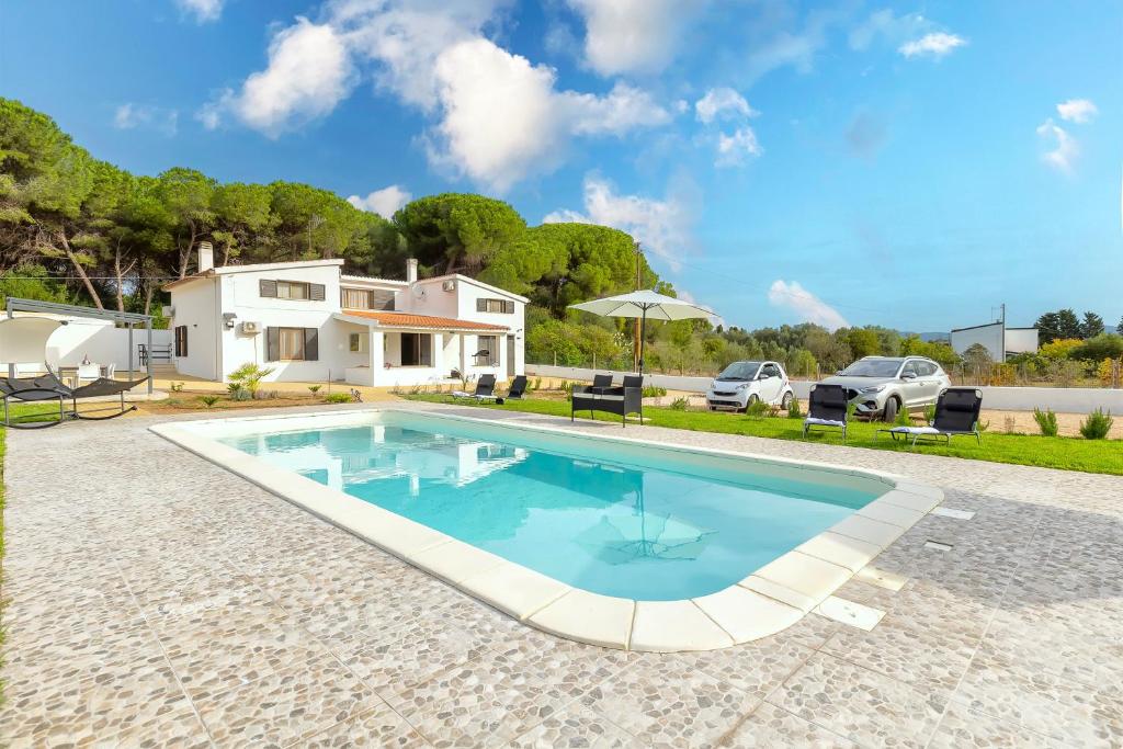 a swimming pool in front of a house at Villa Giovanna in Sorso