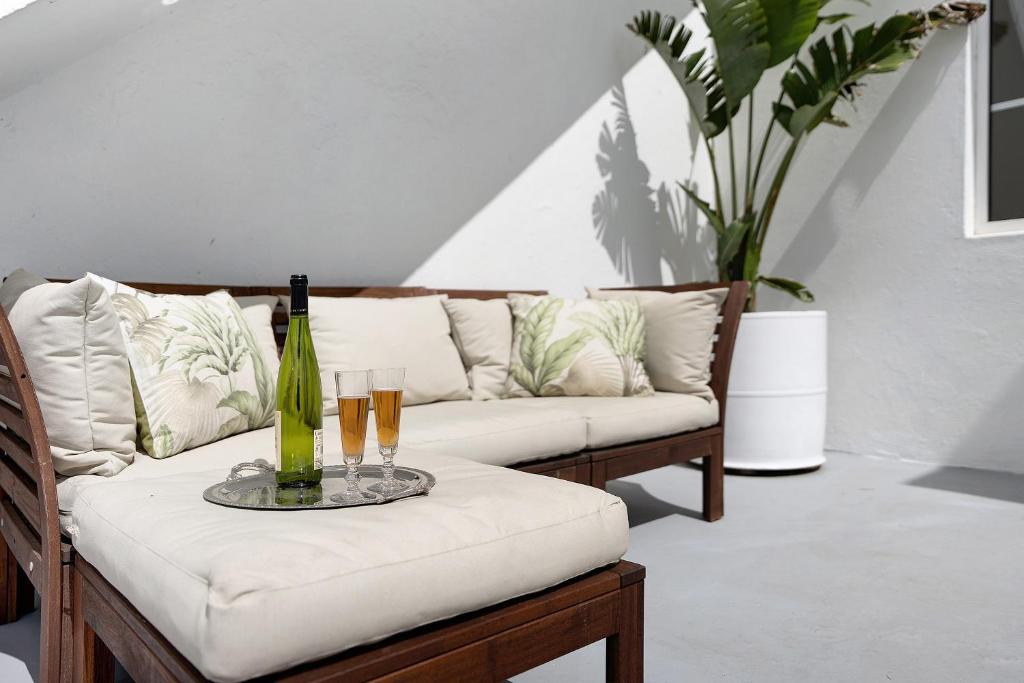 a living room with a couch and a table with champagne glasses at Vista Alegre 22 A in El Paso
