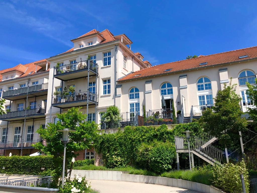 a large white building with a red roof at Schwarzwald Loft Baden-Baden in Baden-Baden