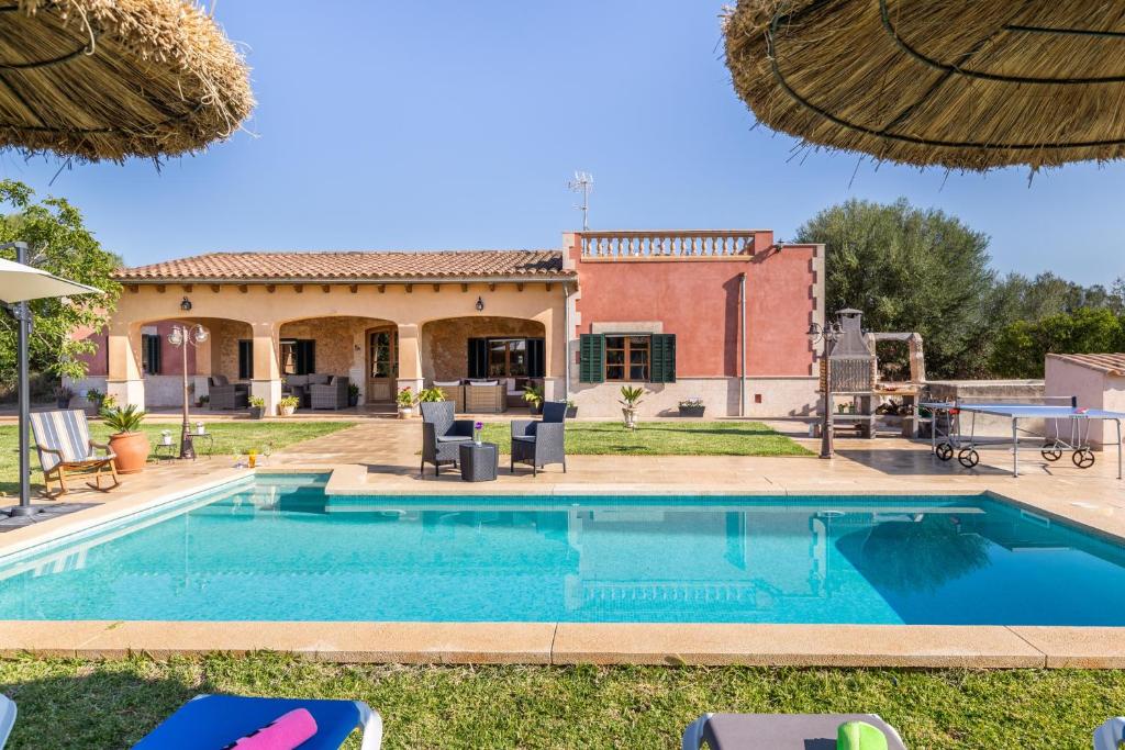 a swimming pool in front of a house at Son Pou in Sencelles