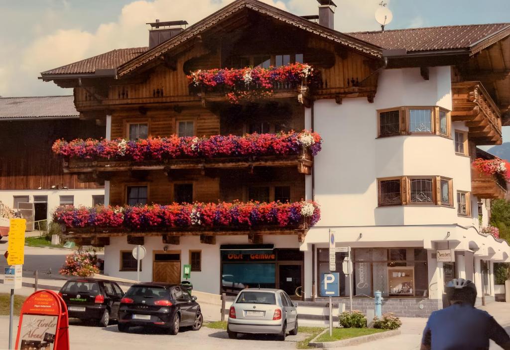 a building with flower boxes on the side of it at Zeunerhof in Fügen