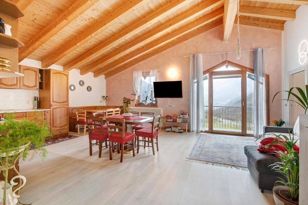a living room with a table and chairs and a tv at Casa Sergio in Grosio