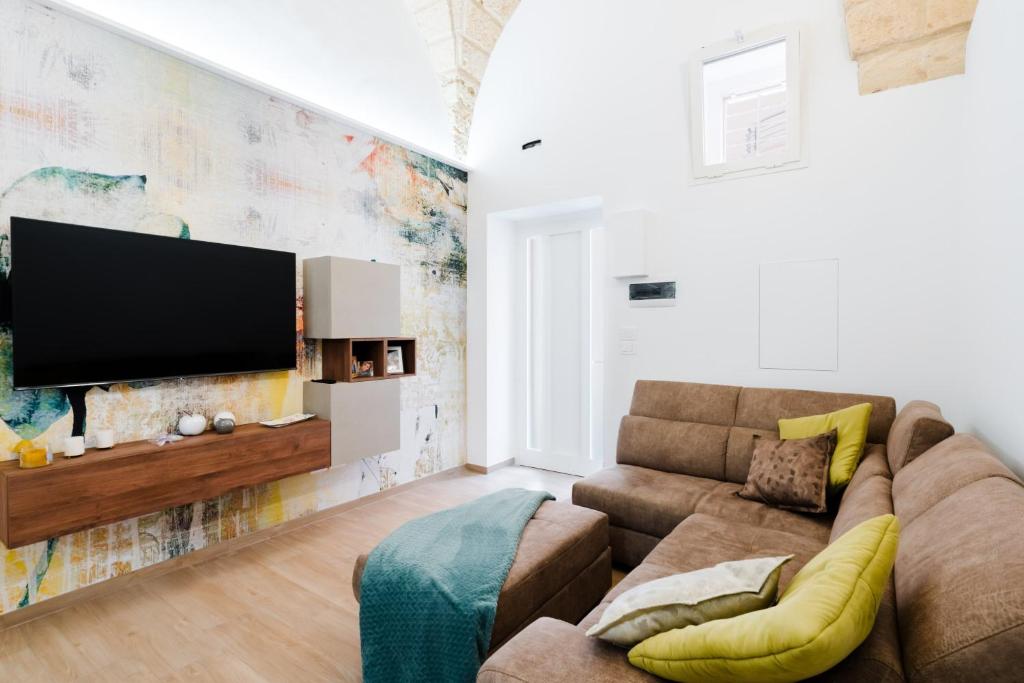 a living room with a couch and a flat screen tv at Casa Ninì in Galatone
