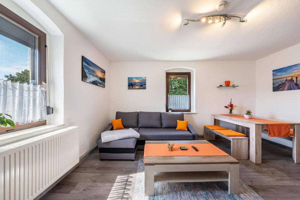a living room with a couch and a table at Freundliche 50m² Ferienwohnung in Sonnenberg