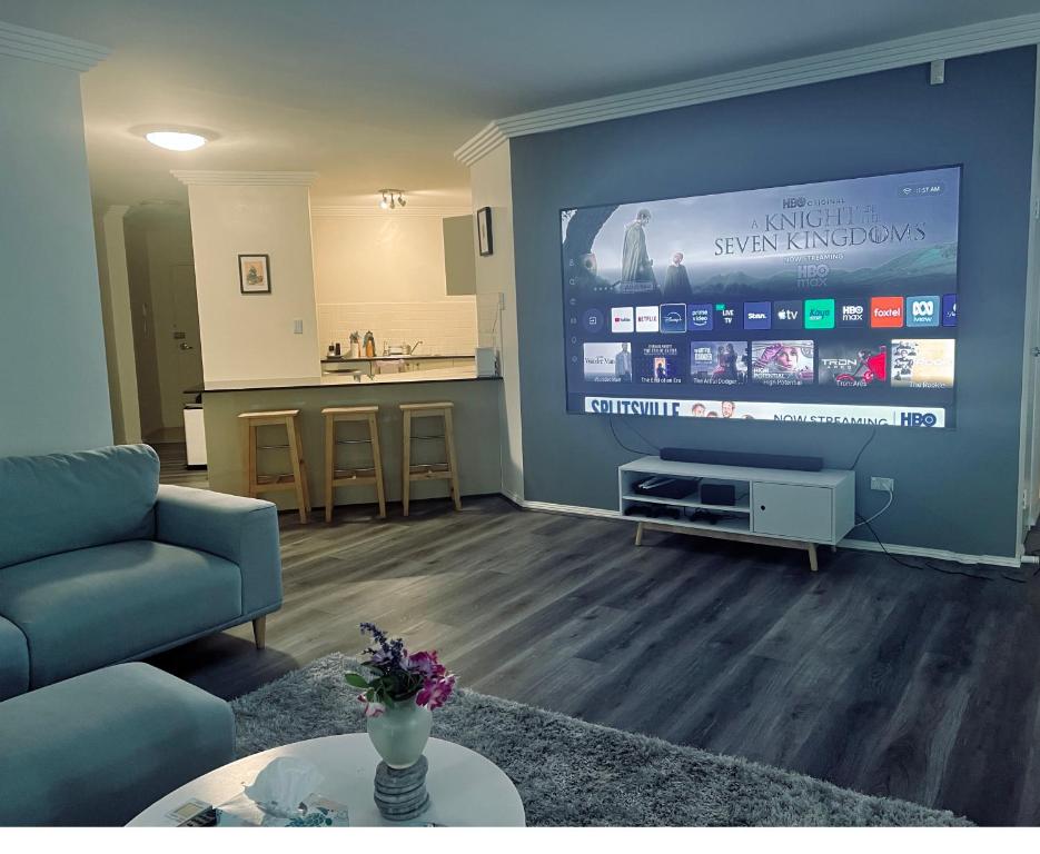 a living room with a large flat screen tv at The Castle in Castle Hill