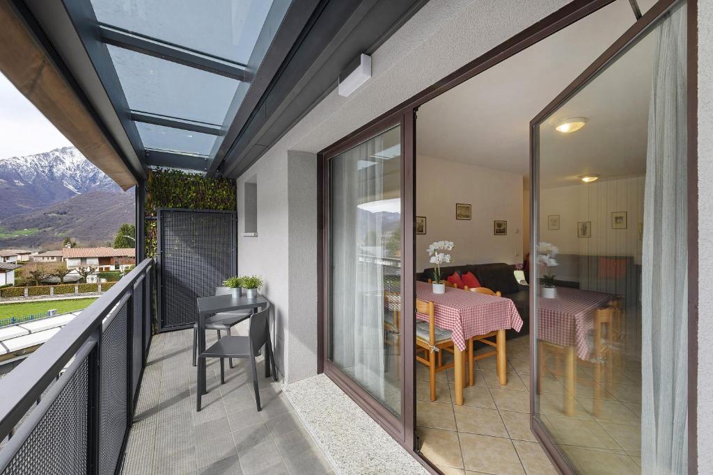 a balcony with a table and chairs on it at Como's Lake Mountains beb in Cremeno