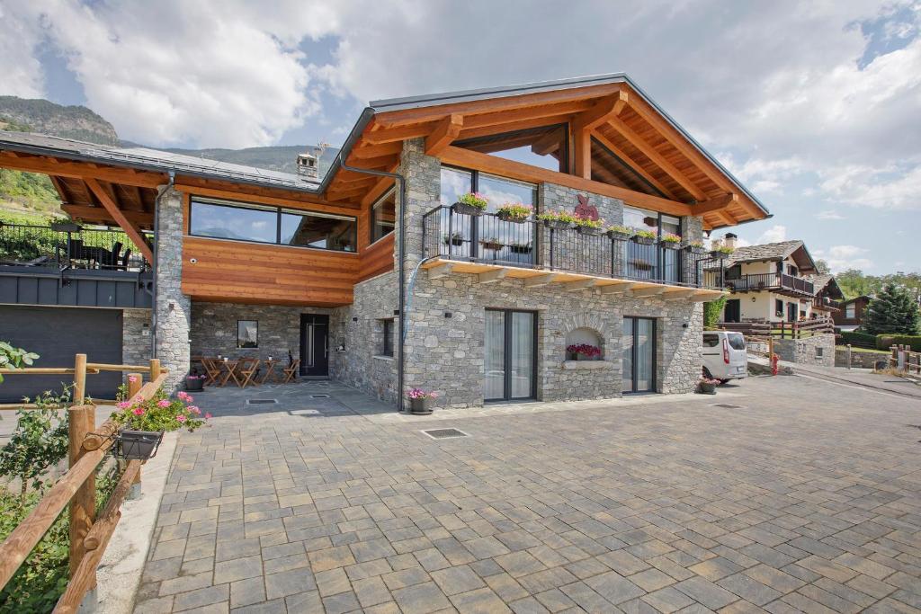 a house with a wooden roof and a patio at La Douce Pomme in Saint-Pierre