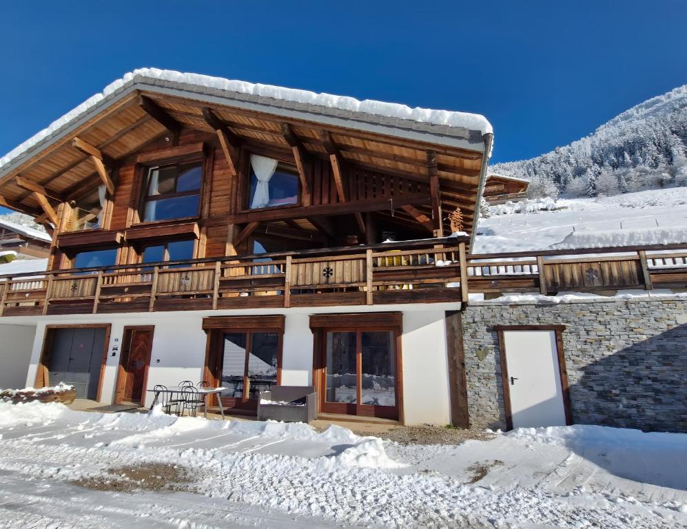 a log home with snow on the ground at L'échappée Belle - Chatel in Châtel