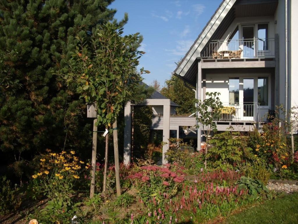 a house with a garden in front of it at Ferienwohnung Auf Dem Schönen Felde in Brilon
