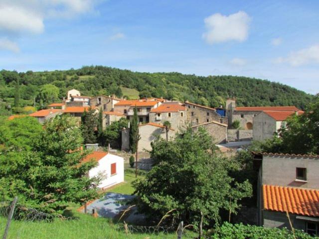 a group of buildings in a town on a hill at Mairie de VIRA in Vira