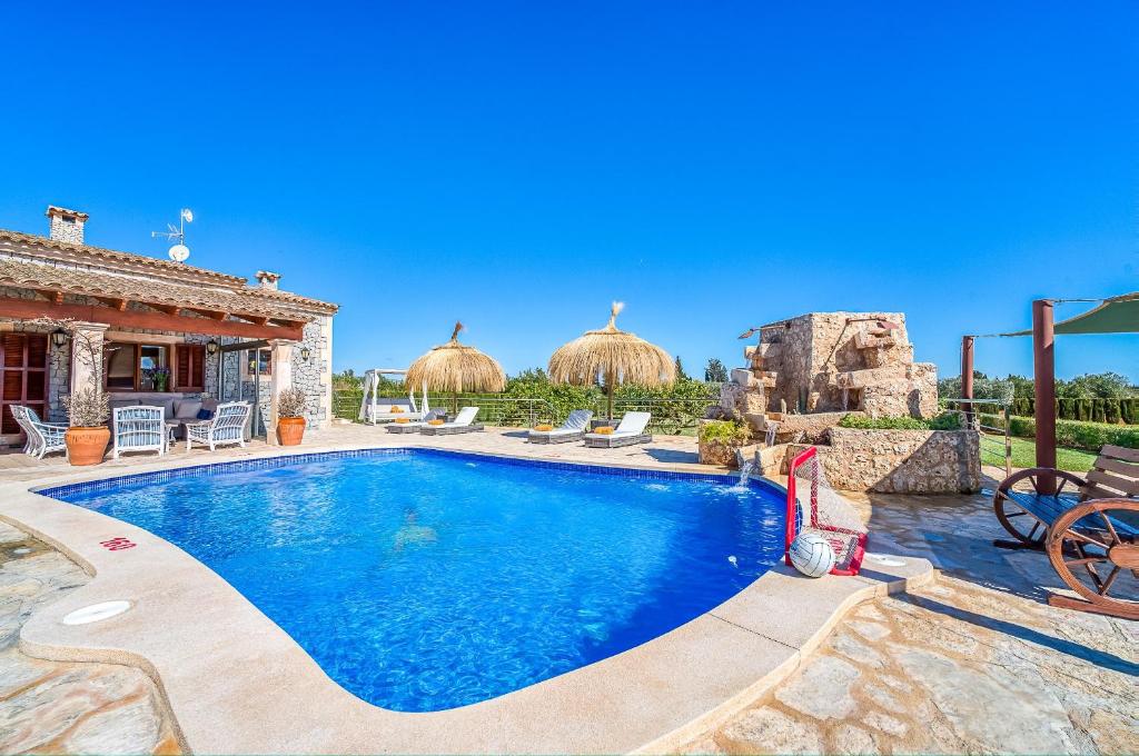 a house with a swimming pool in a yard at Las Naranjas in Muro