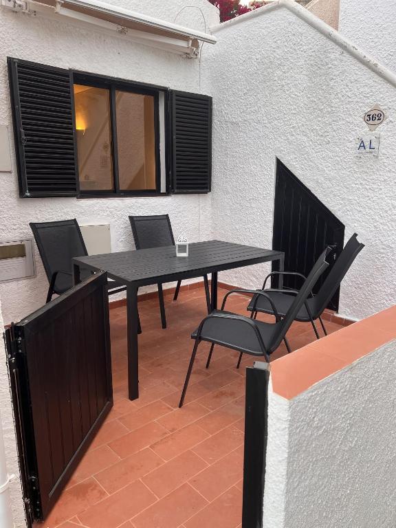 a black table and chairs sitting on a patio at Casa Dade in Tavira