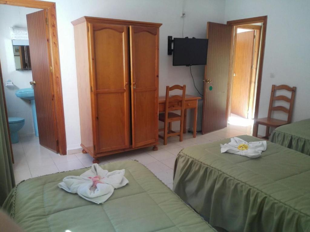 Cama o camas de una habitación en Hostal Mulhacen