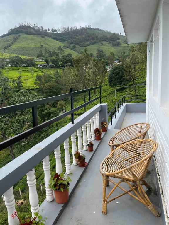 a wicker chair sitting on the balcony of a house with a view at Green Valley in Kolakambe