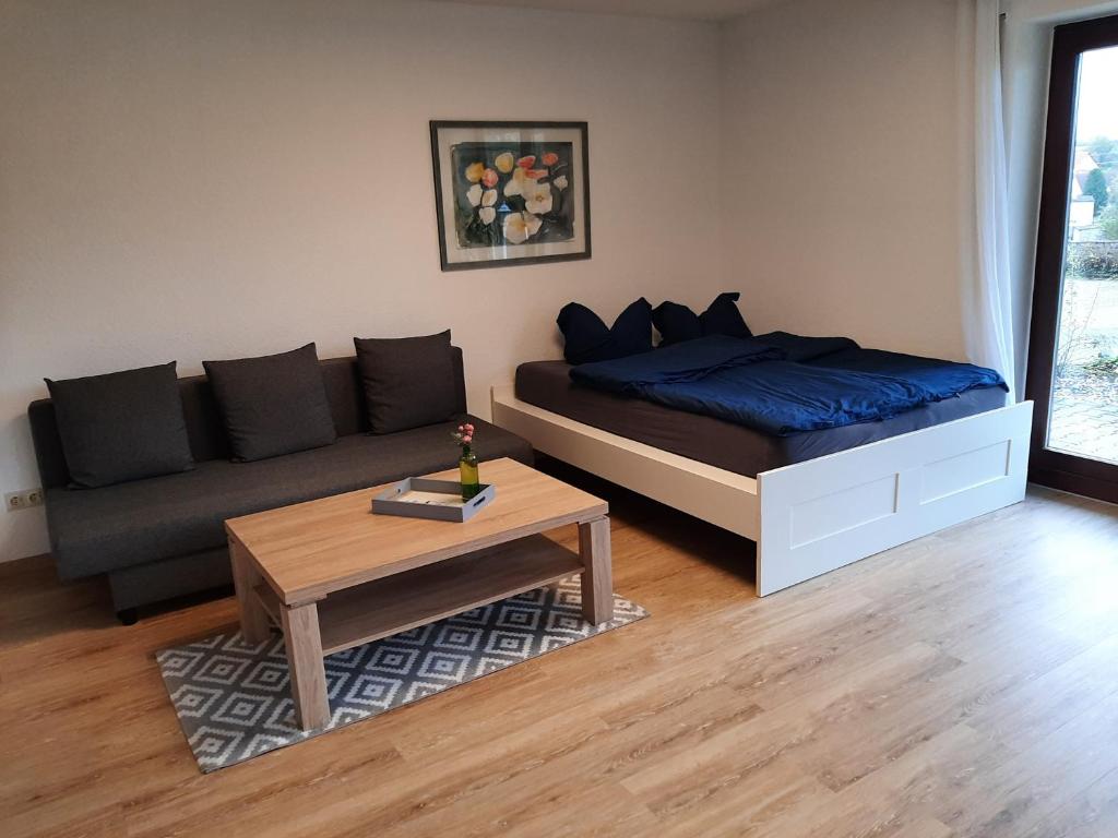 a living room with a bed and a coffee table at Am Dorfweiher in Tettnang