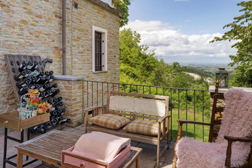 a patio with a bench and a table on a balcony at Locanda Casa Bardacchino in Mango