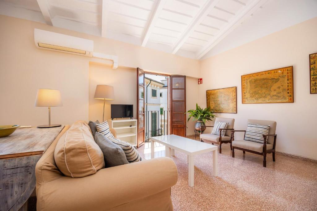 a living room with a couch and a table at Can Claret in Felanitx