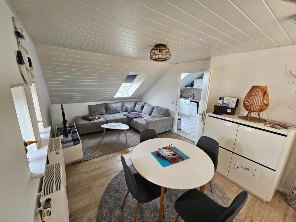 a living room with a table and a couch at Büsummchen in Büsum