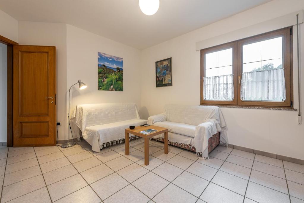 a living room with a couch and a table at Casa Colonia 1 in SantʼAnna Arresi