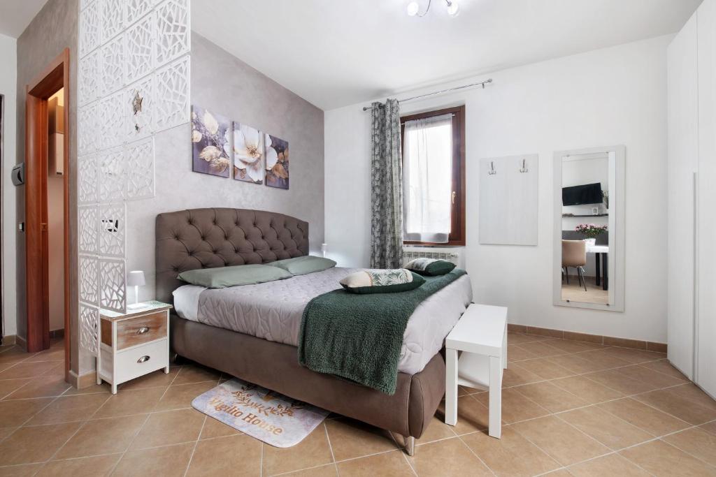 a bedroom with a bed and a table and a mirror at Vigilio house in Calco