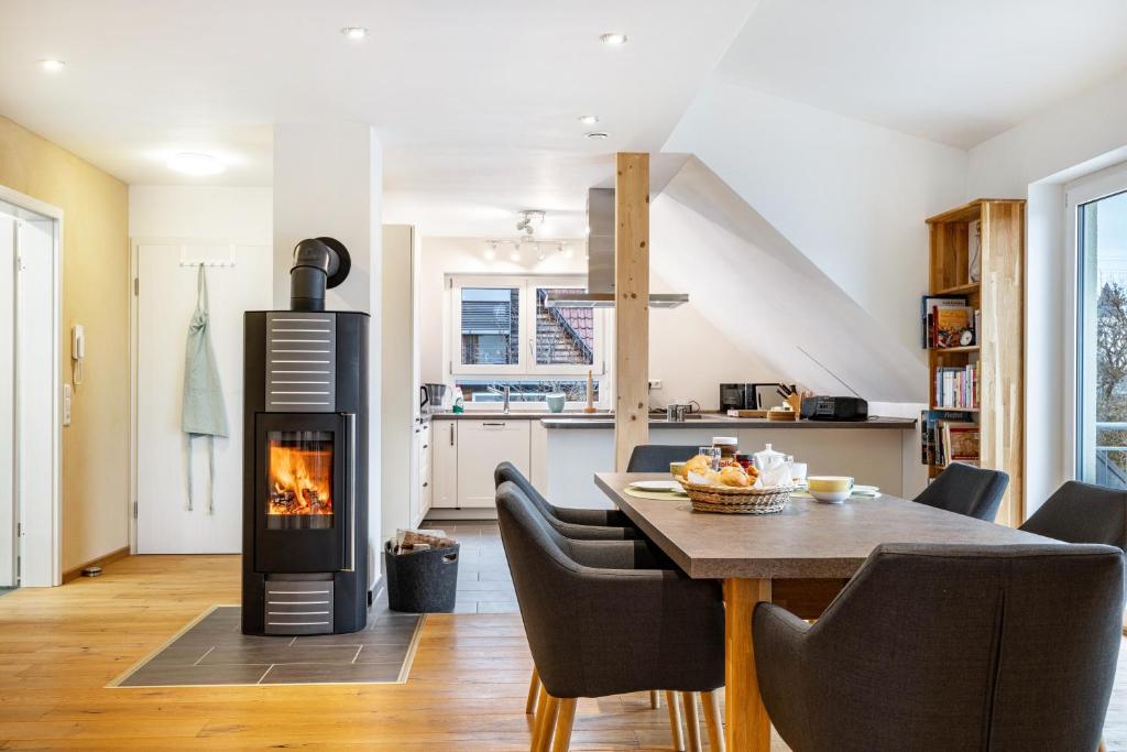a kitchen and dining room with a wood burning stove at Ferienwohnung Schatz in Albstadt