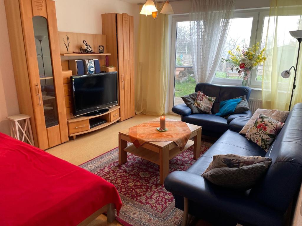 a living room with two couches and a tv at Ferienwohnung Ingrid Rautenberg in Krautheim