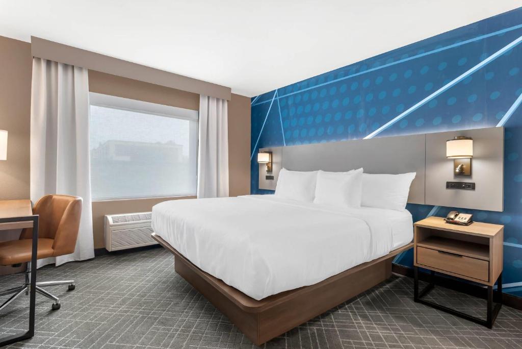 a hotel room with a bed and a window at Comfort Inn & Suites Suwanee - Sugarloaf in Suwanee