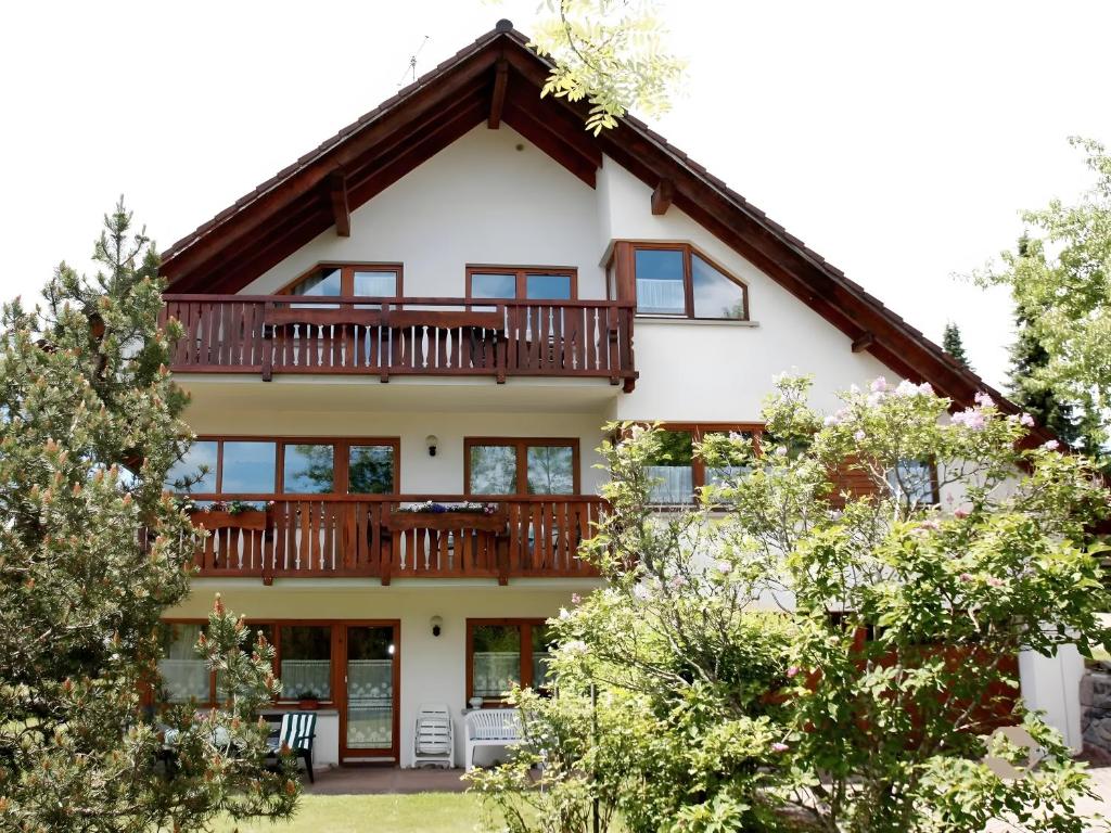 a large white house with a large deck at Haus Marianne Dörflinger in Schluchsee