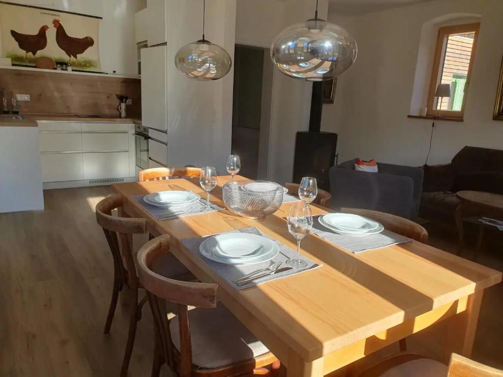 a wooden table with plates and wine glasses on it at Zauberhaftes Franken erleben in Gräfendorf