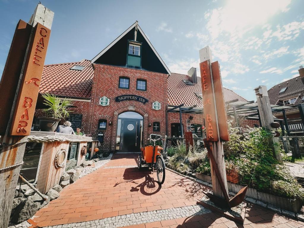 a bike parked in front of a brick building at Skippers Inn in Baltrum
