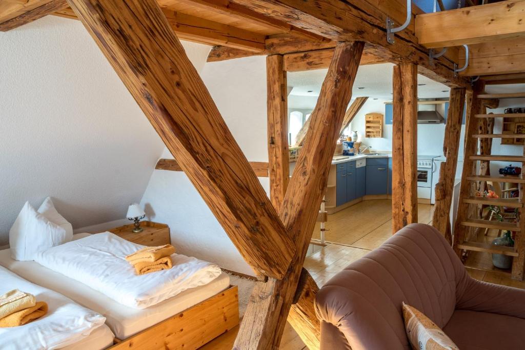 a room with two beds and a living room at Ferienwohnung Am Heideborn in Großschönau