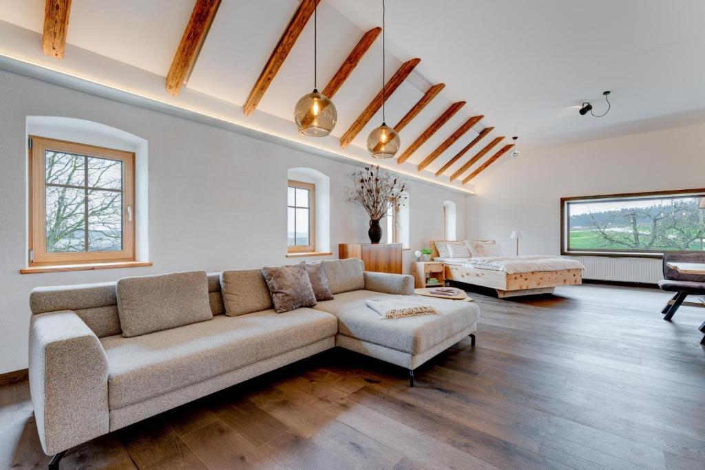 a living room with a couch and a table at Außergewöhnliches Loft Senftenbach in Senftenbach