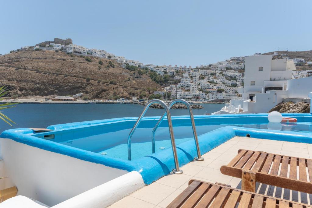 a swimming pool on the roof of a villa with a view of the ocean at Caldera Studios in Astypalaia