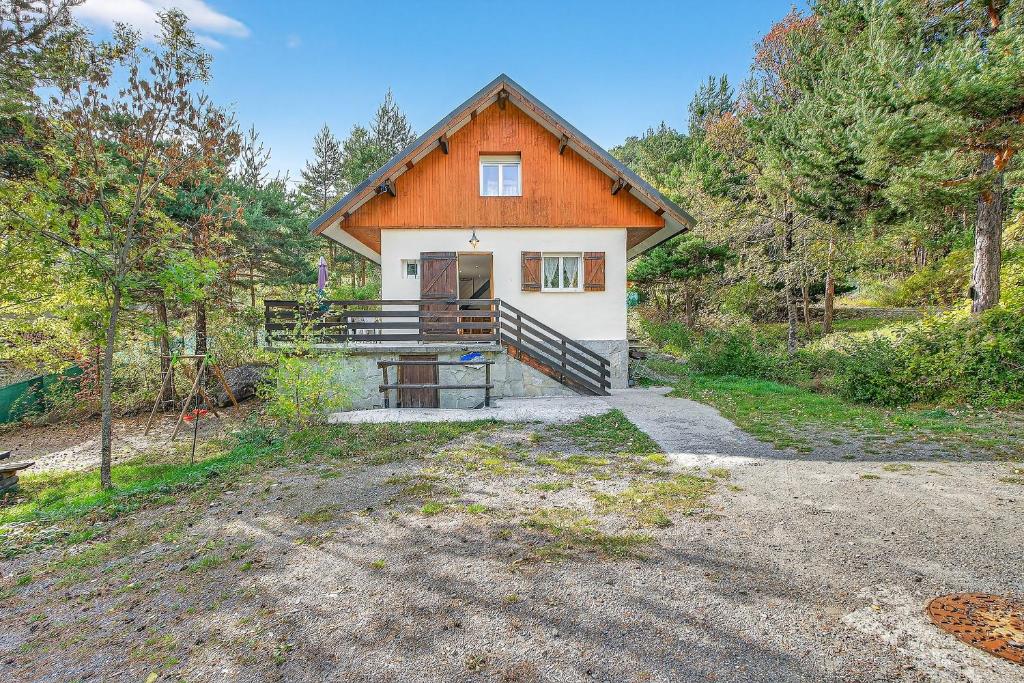 a house with an orange roof in the woods at Chalet Ma Bonne Etoile in Les Prats
