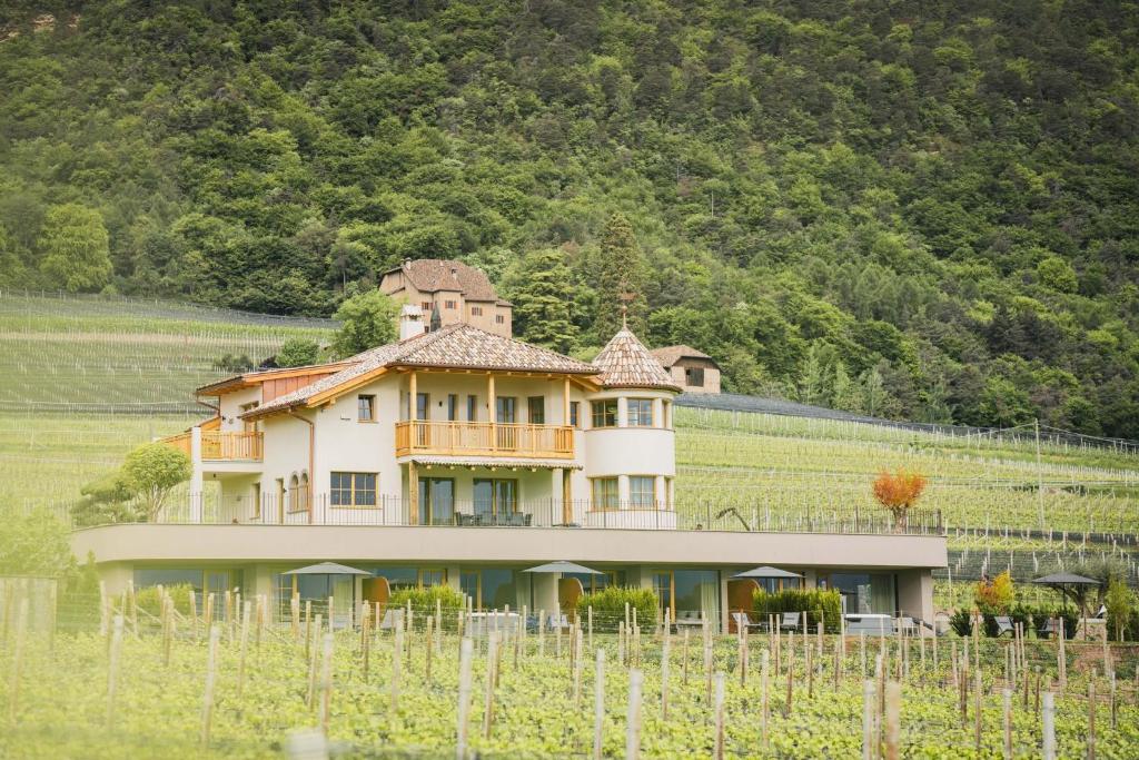 a large house in the middle of a field at Valentinerhof Apt Air in San Michele