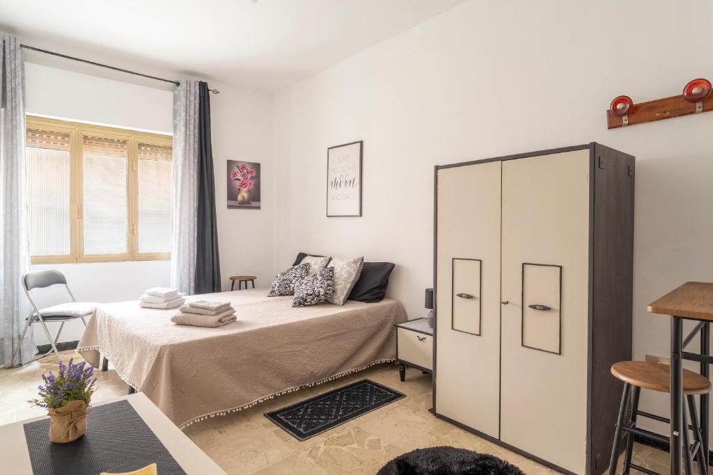 a bedroom with a bed and a cabinet at Jerzu Centro in Jerzu