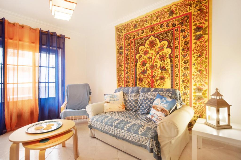 a living room with a couch and a rug at A O - La Source in Peniche