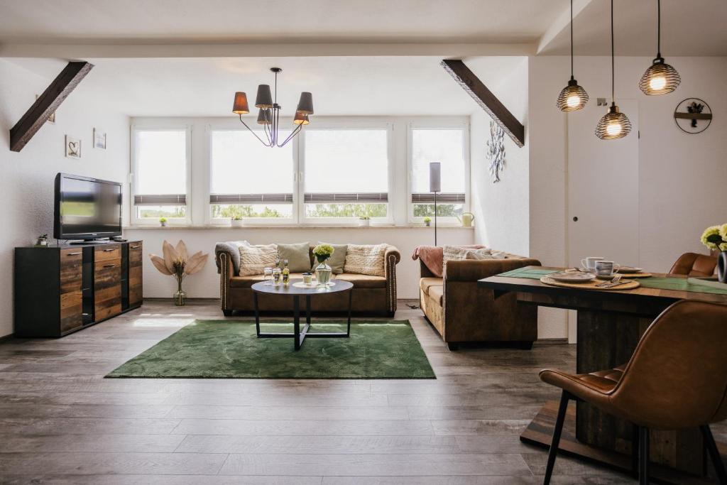 a living room with a couch and a table at Ferienwohnung Emma in Güntersberge