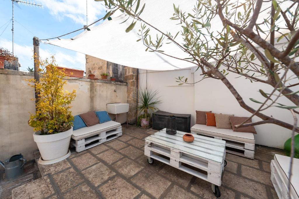 a patio with two couches and a fire place at La Cartapesta in Lecce