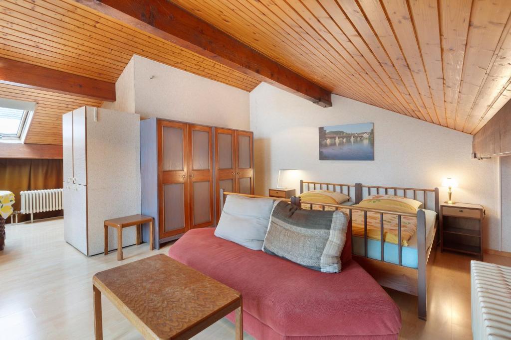 a living room with a bed and a refrigerator at Haus Koch in Bad Säckingen