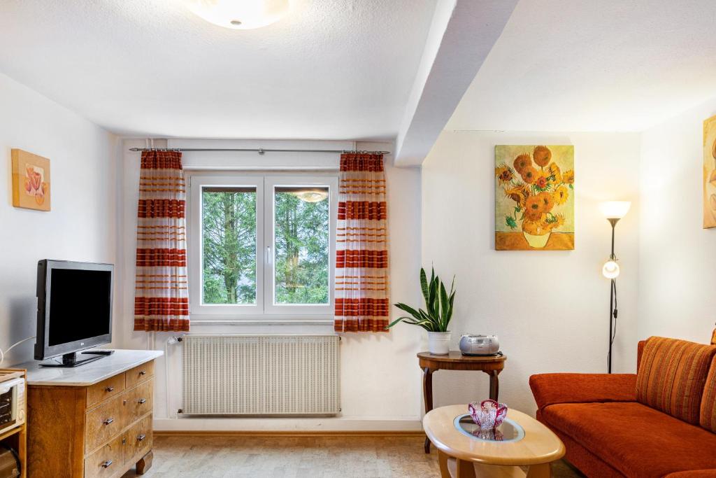 a living room with a couch and a window at Haus Edith in Gersfeld