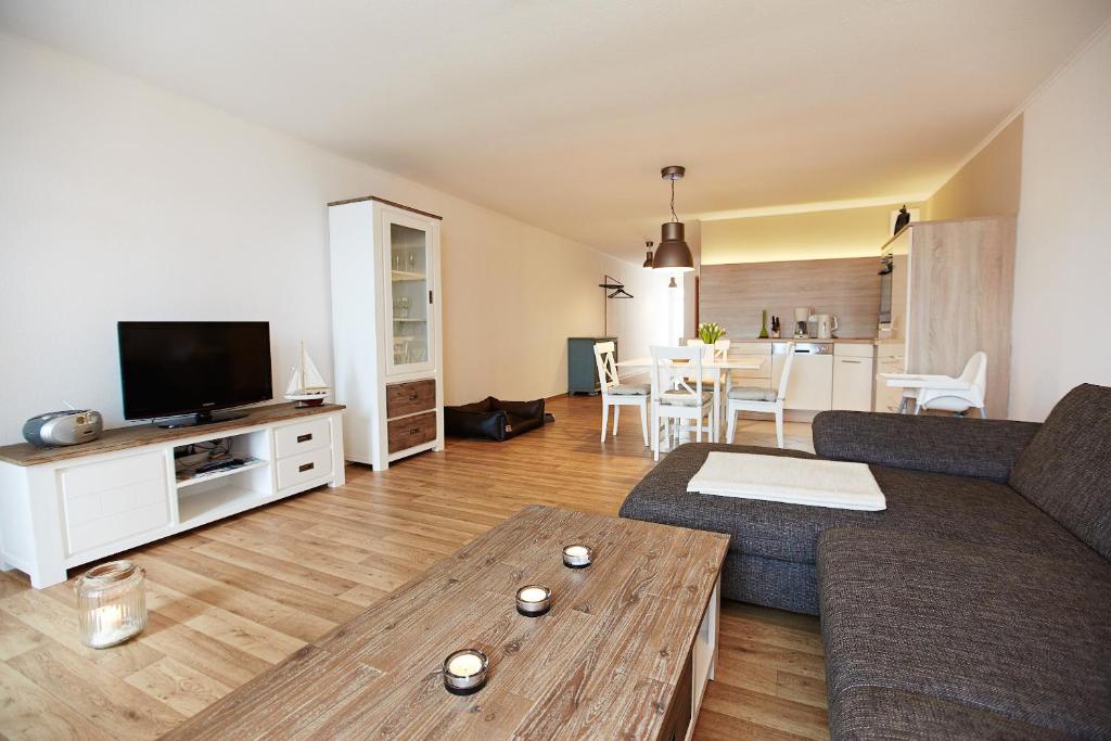 a living room with a couch and a table at Haus Strandeck Nordstrand 18 in Göhren