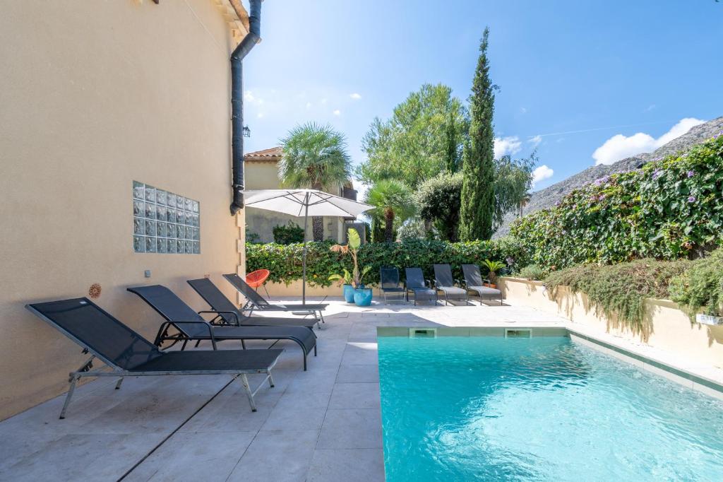 a patio with chairs and a swimming pool at Villa Sant Vicente in Cala de Sant Vicenc