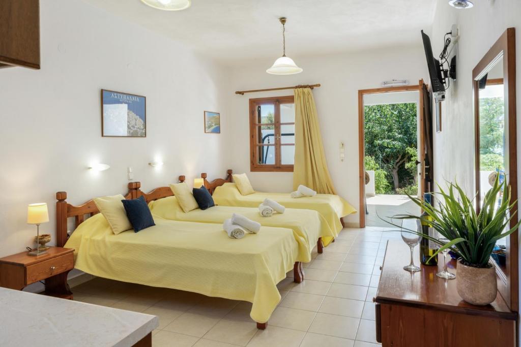 a bedroom with four beds in a room at Studios Asterias 4 in Astypalaia