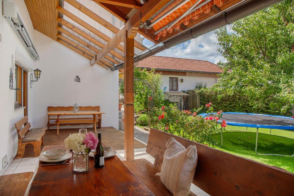 a patio with a table and a swimming pool at Auszeit Brunner in Bad Tölz