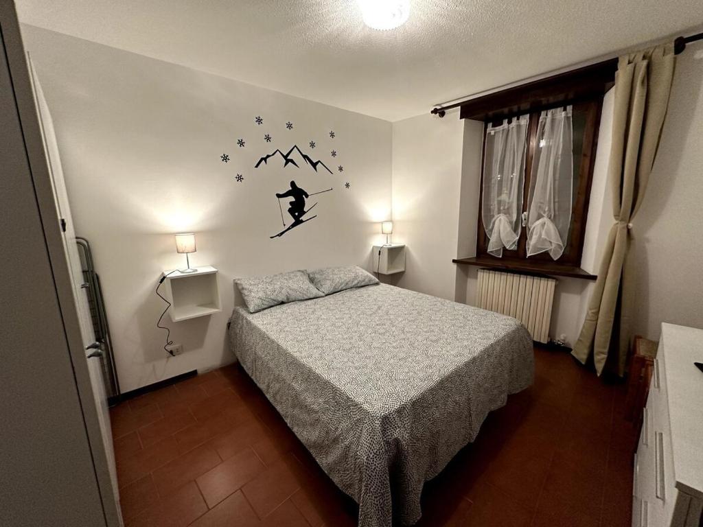 a bedroom with a bed and a wall with stars at Appartamento Bardonecchia in Bardonecchia