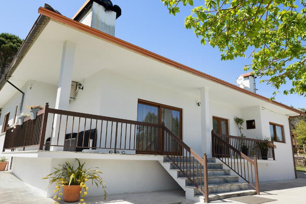 a white house with stairs in front of it at Vermarl - Viana do Castelo in Linhares de Cima