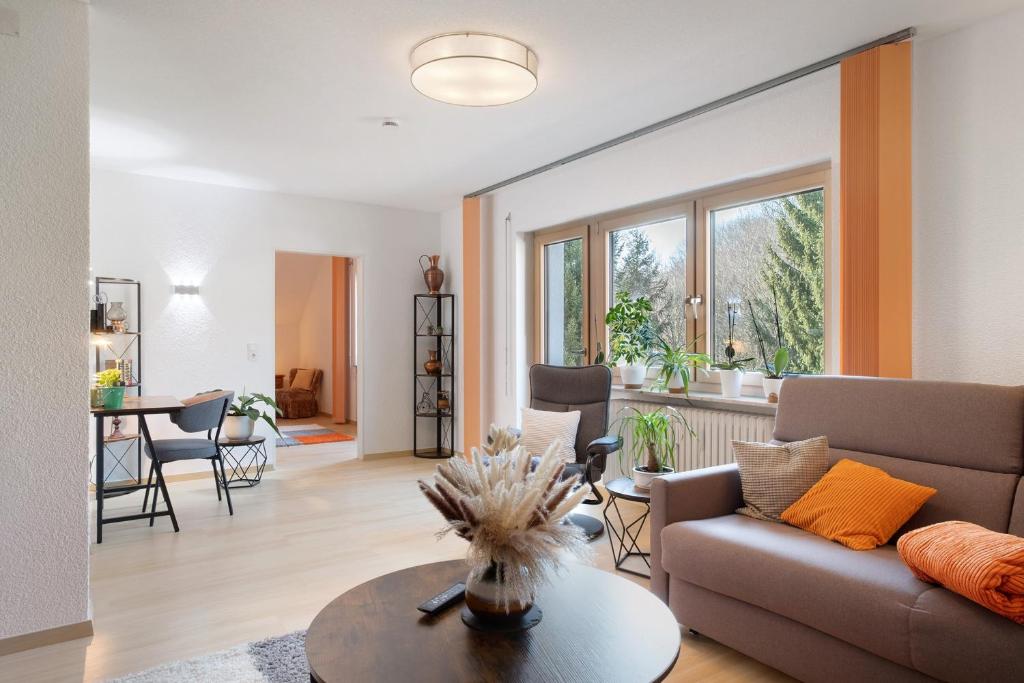 a living room with a couch and a table at Fewo Kessler Waldblick in Häusern