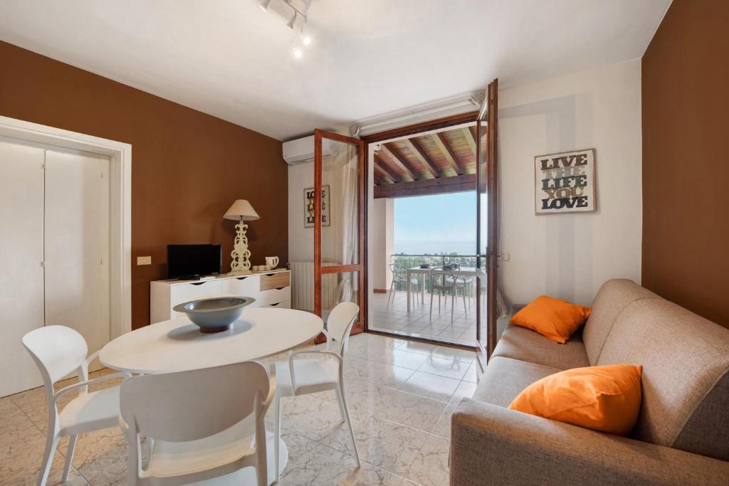 a living room with a couch and a table at vista lago apartment 1 in Soiano del Lago